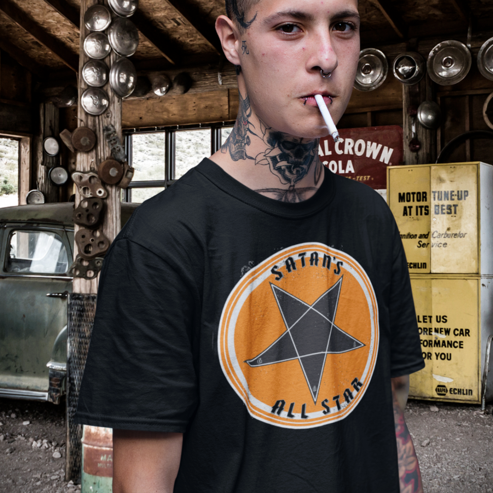 A young gearhead is in an old garage with his vintage hot rod. He is wearing The Satan's All Star T-Shirt from Asphalt Anarchist Clothing Co. KUSTOM KULTURE APPAREL & PRODUCTS